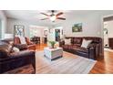 Cozy living room showcasing hardwood floors, a ceiling fan, and comfortable leather furniture, perfect for relaxation at 2771 Stonecreek Se Rd, Smyrna, GA 30080