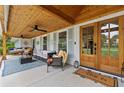 Inviting front porch with stylish seating, wood ceiling, and a welcoming entrance at 3967 Manson Se Ave, Smyrna, GA 30082