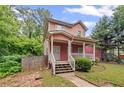 Inviting two-story home featuring a classic front porch and mature landscaping for a serene curb appeal at 2171 Wilson Nw Ave, Atlanta, GA 30314
