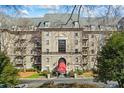 Beautiful building facade with lush trees and landscaping, making it a desirable residential property at 2865 Lenox Ne Rd # 211, Atlanta, GA 30324