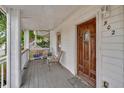 Inviting front porch with seating area and a beautiful wood door at 902 Allene Sw Ave, Atlanta, GA 30310