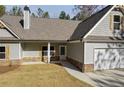 Single-Gathering home boasts a two-car garage, stone accents, gabled roof, and a well-maintained front yard at Lot 1 Perkins Rd, Dallas, GA 30157