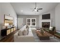 Inviting living room featuring a stone fireplace, mantle-mounted TV, comfortable seating, and natural light at Lot 1 Perkins Rd, Dallas, GA 30157