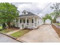 Quaint home with inviting front porch, long drive way and separate garage at 1555 New Ne St, Atlanta, GA 30307