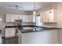 Modern kitchen featuring white cabinetry, stainless steel appliances, and sleek granite countertops at 1555 New Ne St, Atlanta, GA 30307
