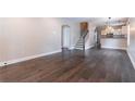 Spacious living room with hardwood floors, staircase, and view into the modern kitchen at 1555 New Ne St, Atlanta, GA 30307