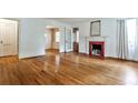 Bright living room featuring hardwood floors, fireplace, and plenty of natural light at 1798 Melrose Sw Dr, Atlanta, GA 30310