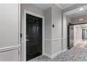 Hallway featuring a black door, neutral walls, and patterned carpeting at 3636 Habersham Nw Rd # 2101, Atlanta, GA 30305