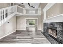 Bright living room featuring fireplace, lots of natural light and beautiful laminate flooring at 60 Whispering Pine Ct, Covington, GA 30016