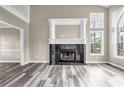 Bright living room featuring fireplace, lots of natural light and beautiful laminate flooring at 60 Whispering Pine Ct, Covington, GA 30016