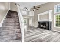 Bright living room featuring fireplace, lots of natural light and beautiful laminate flooring at 60 Whispering Pine Ct, Covington, GA 30016