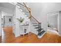 Bright foyer with hardwood floors, a staircase with decorative iron railings, and neutral paint at 815 Lake Forest Pass, Roswell, GA 30076