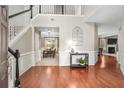 Elegant foyer featuring hardwood floors, staircase, and dining room view at 103 Harvest Rdg, Acworth, GA 30102