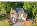 An aerial view showcasing a two-story home with manicured lawn and driveway at 2114 Lindley Nw Ln, Kennesaw, GA 30144