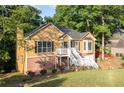 Delightful two-story home with a brick foundation, white stairs, and a beautifully landscaped front yard at 2114 Lindley Nw Ln, Kennesaw, GA 30144