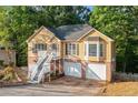 Charming two-story home featuring a brick foundation, white stairs, and a well-manicured lawn at 2114 Lindley Nw Ln, Kennesaw, GA 30144