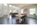 Open-concept dining area with hardwood floors, modern lighting, and access to the living room at 3985 Starwood Dr, Cumming, GA 30028