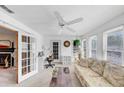 Inviting sunroom features bright light, a ceiling fan, and glass doors that lead to an adjacent room at 4118 Stillwater Dr, Duluth, GA 30096