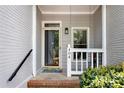 Inviting front porch featuring brick steps and white railing at 404 Carryback Dr, Marietta, GA 30068