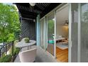A cozy balcony overlooks a refreshing pool and green surroundings, providing a serene outdoor retreat at 120 Alden Nw Ave # C3, Atlanta, GA 30309