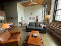 Bright open living space with exposed brick, a comfortable seating area, and natural light at 170 Boulevard Se # H301, Atlanta, GA 30312