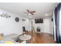 Cozy living room featuring hardwood floors, modern decor, and a ceiling fan at 2462 Pate S St, Snellville, GA 30078