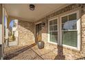 Covered front porch with brick flooring, white columns, and a view of the neighborhood at 4505 Caroline Walk, Dunwoody, GA 30338