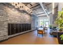 Modern lobby featuring exposed brick, mailboxes, comfortable seating, and stylish lighting at 112 Rogers St # 208, Atlanta, GA 30317