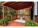 Cozy porch with an outdoor rug, fern plants, and seating under a pergola with string lights at 1350 Overlook Se Cv, Smyrna, GA 30080
