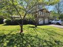 Inviting split-level home with a well-manicured lawn and ample parking on the driveway at 4457 Huntshire Dr, Stone Mountain, GA 30083