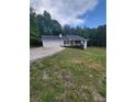 Charming home with a two-car garage and a lush yard at 129 Carolyn Path, Rockmart, GA 30153