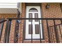 Close up of the lovely, white front door framed by brick with black railing on the stoop at 2469 Silver King Dr, Grayson, GA 30017
