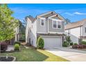 Charming two-story home with a two-car garage and gray siding, complemented by manicured landscaping at 2769 Morgan Spring Trl, Buford, GA 30519