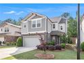 Charming two-story home with a two-car garage and gray siding, complemented by manicured landscaping at 2769 Morgan Spring Trl, Buford, GA 30519
