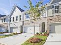 Attractive townhome complex with brick and siding, featuring attached garages and landscaped front yards at 4663 Larkfield Way, Powder Springs, GA 30127