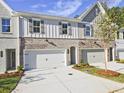 Inviting townhome showcasing brick and siding facade, individual driveways, and well-manicured landscaping at 4663 Larkfield Way, Powder Springs, GA 30127