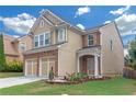 Charming two-story home with brick accents, well-manicured lawn, and a two-car garage at 5645 Carrington Pl, Cumming, GA 30040