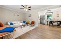 Bright living room features a modern ceiling fan and an adjacent dining area with stainless steel appliances at 2125 Lynn Sw Dr, Marietta, GA 30060