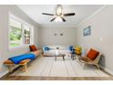 Light-filled living room boasts neutral walls, a ceiling fan, and an abundance of natural light from a large window at 2125 Lynn Sw Dr, Marietta, GA 30060