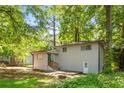 The backyard shows a wooden deck, walk out basement and stairs leading up to the main level at 271 Leafwood Ln, Riverdale, GA 30274