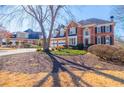 Charming brick home with a two-car garage and mature trees, offering a picturesque curb appeal at 1018 Jubilee Way, Powder Springs, GA 30127