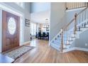 Grand foyer with hardwood floors, staircase, and views to the dining room creates an elegant entrance at 1018 Jubilee Way, Powder Springs, GA 30127