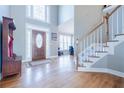 Inviting foyer with hardwood floors, a staircase, and a decorative front door at 1018 Jubilee Way, Powder Springs, GA 30127