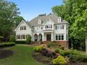 Stately two-story home featuring beautiful landscaping, a well-kept lawn, and a welcoming covered front porch at 2616 Boddie Pl, Duluth, GA 30097