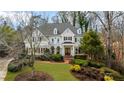 Charming two-story home with lush landscaping, a manicured lawn, and a welcoming brick walkway at 2616 Boddie Pl, Duluth, GA 30097