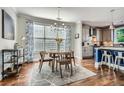 Dining area featuring hardwood floors, modern lighting, and natural light from the large window at 2686 Oak Leaf Se Pl, Atlanta, GA 30316