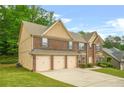 Spacious brick home with a three-car garage and well-maintained lawn at 4616 Town Manor Dr, Douglasville, GA 30135