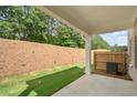 Backyard view with a new patio, grass and a privacy fence on a lot with a grade at 4667 Larkfield Way, Powder Springs, GA 30127