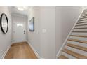 Light filled foyer with wood floors and stairs to second level at 4667 Larkfield Way, Powder Springs, GA 30127