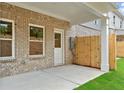 Outdoor patio area with brick exterior and a newly constructed wooden privacy fence at 4667 Larkfield Way, Powder Springs, GA 30127